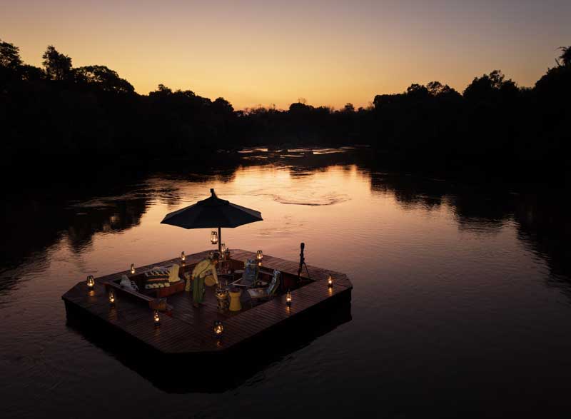 Amura,AmuraWorld,AmuraYachts, An elegant dinner aboard a pontoon boat cruising the Kafue River.