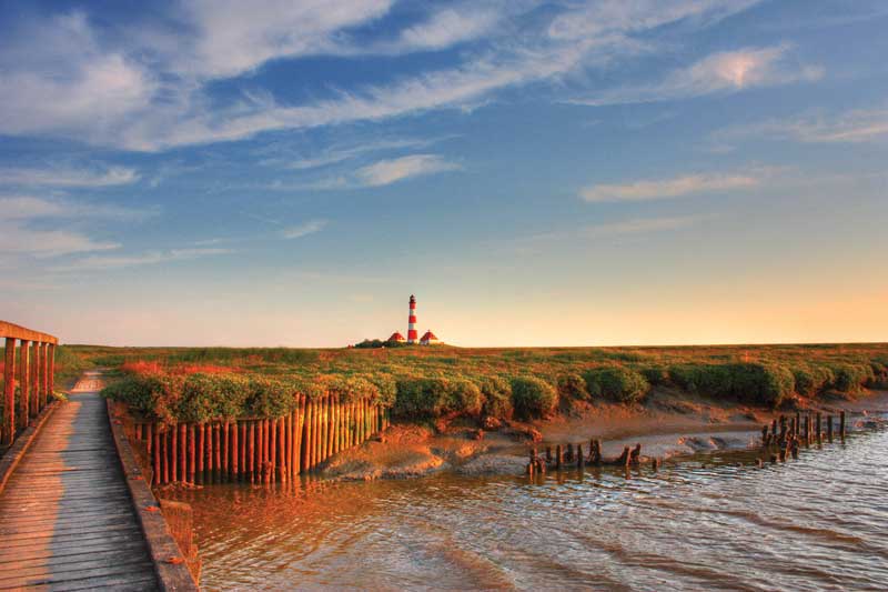 Lighthouse Westerhever, a German landscape of the Wadden Sea. 
